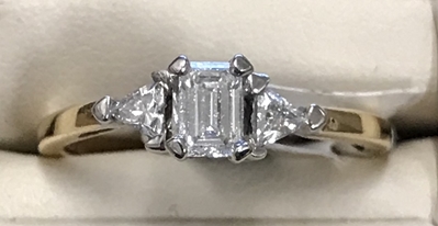 1/2cttw Emerald cut with Trillons Diamond ring 